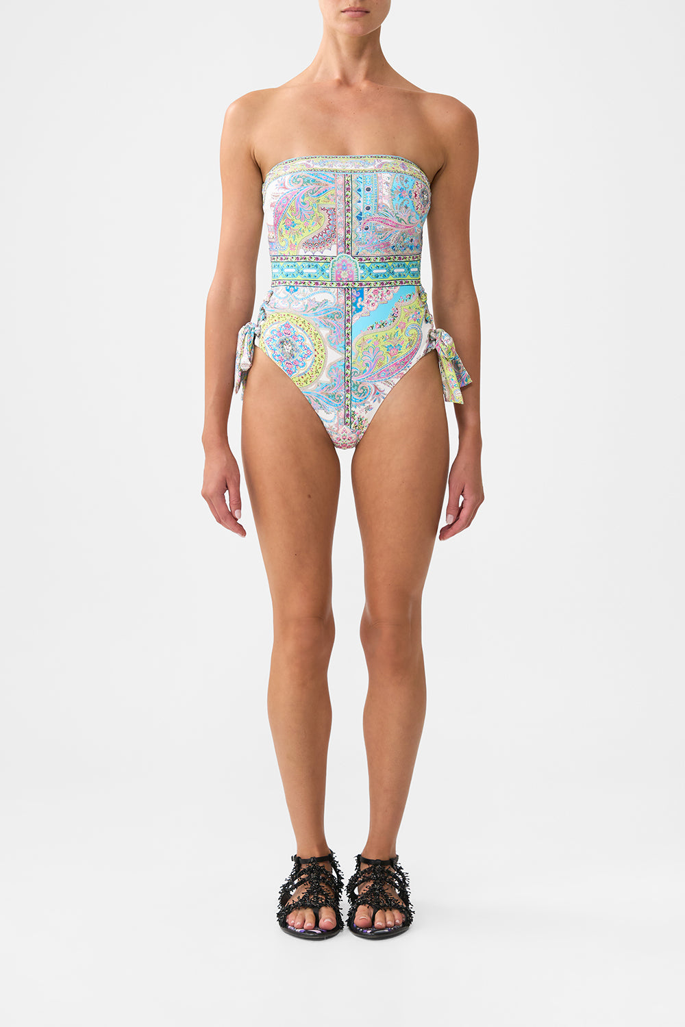 The CAMILLA BANDEAU ONE PIECE WITH EYELET TIE SIDES MAGIC CARPET RIDEMAGIC CARPET RIDE