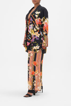 Side view of model wearing CAMILLA  silk jacket in Secret History floral print