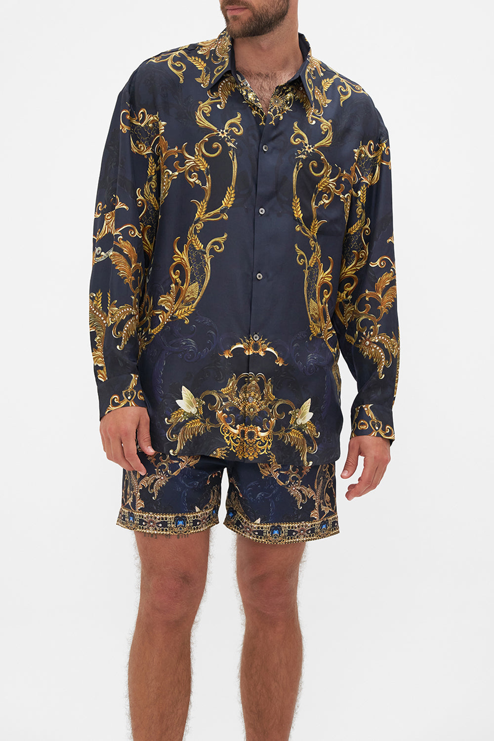 Crop view of model wearing Hotel Franks By CAMILLA mens oversized shirt in Moonlight Melodies print