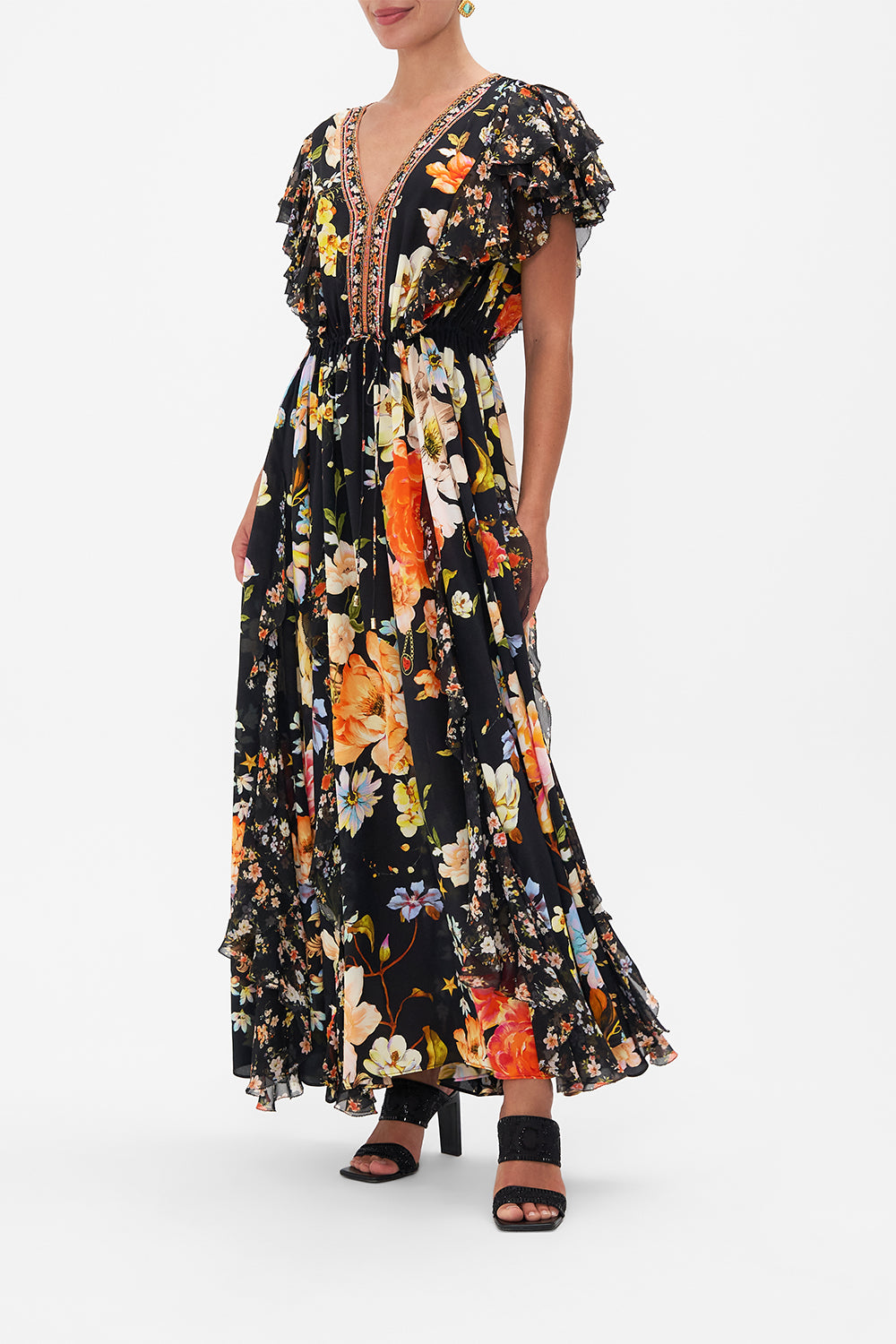 Side view of model wearing CAMILLA silk ruffle maxi dress in Secret History floral print
