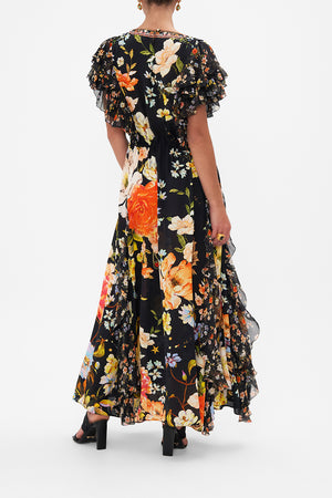 Back view of model wearing CAMILLA silk ruffle maxi dress in Secret History floral print